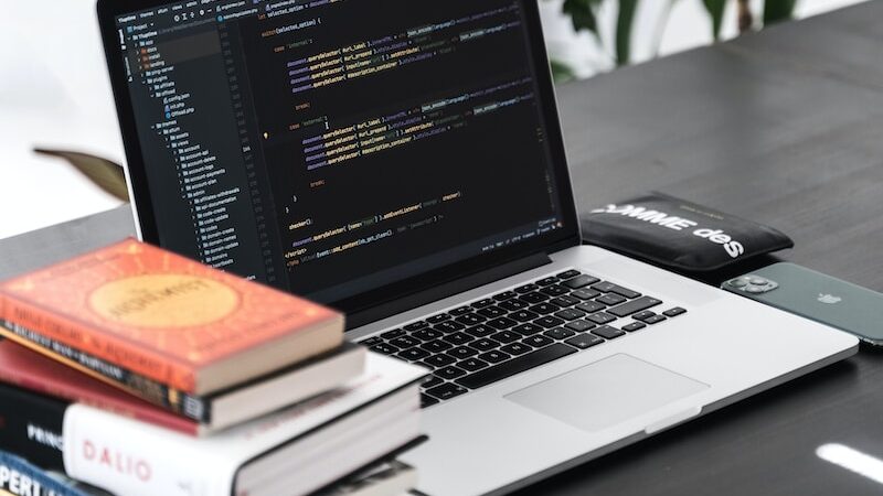 macbook pro on black wooden table | best coding schools in Kenya