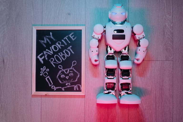 AI in Education: How Zindua School is Transforming Learning with AI 3 Playful scene of a white robot toy and chalkboard drawing on wooden floor. (Blog: AI in education)