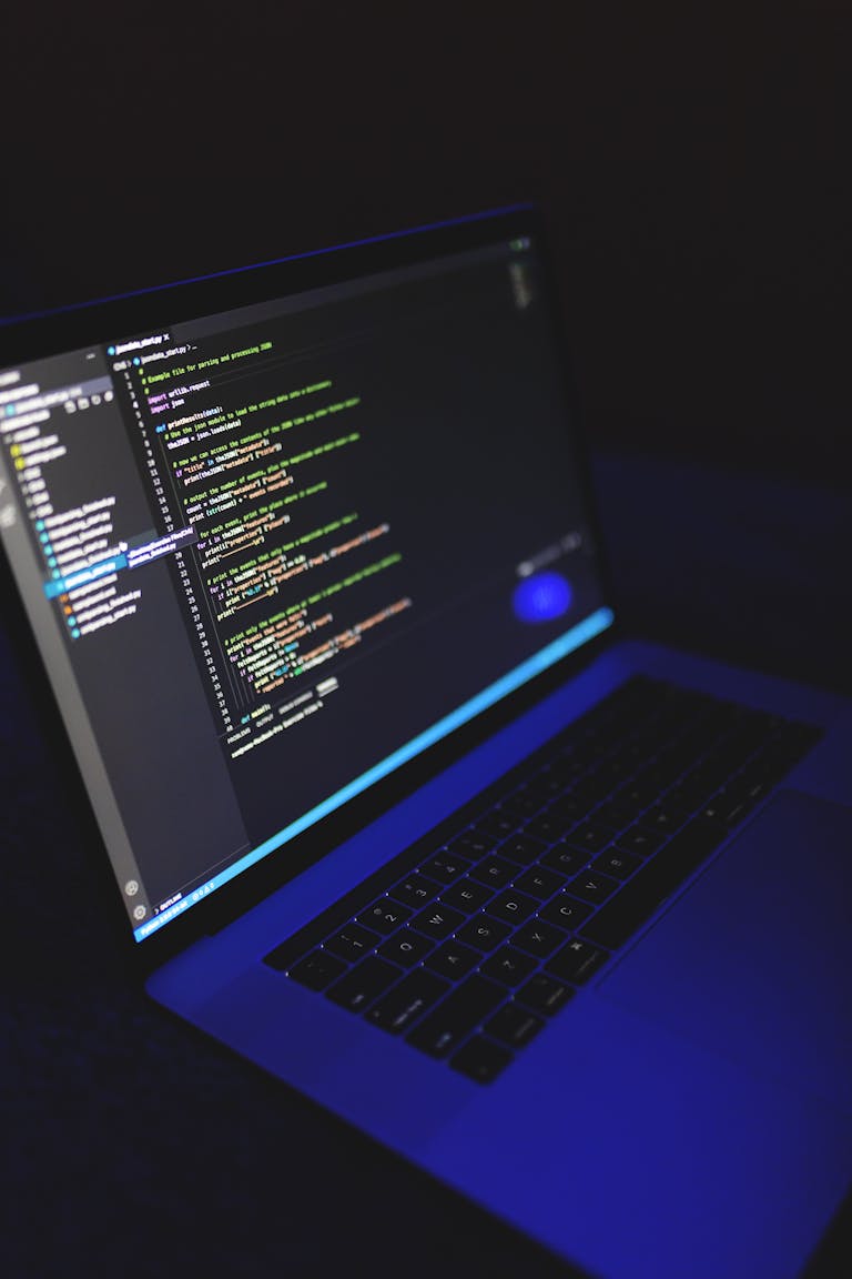 The Top 5 In-Demand Tech Careers in 2025 2 A laptop showcasing colorful code in a dark environment, ideal for tech or programming content.