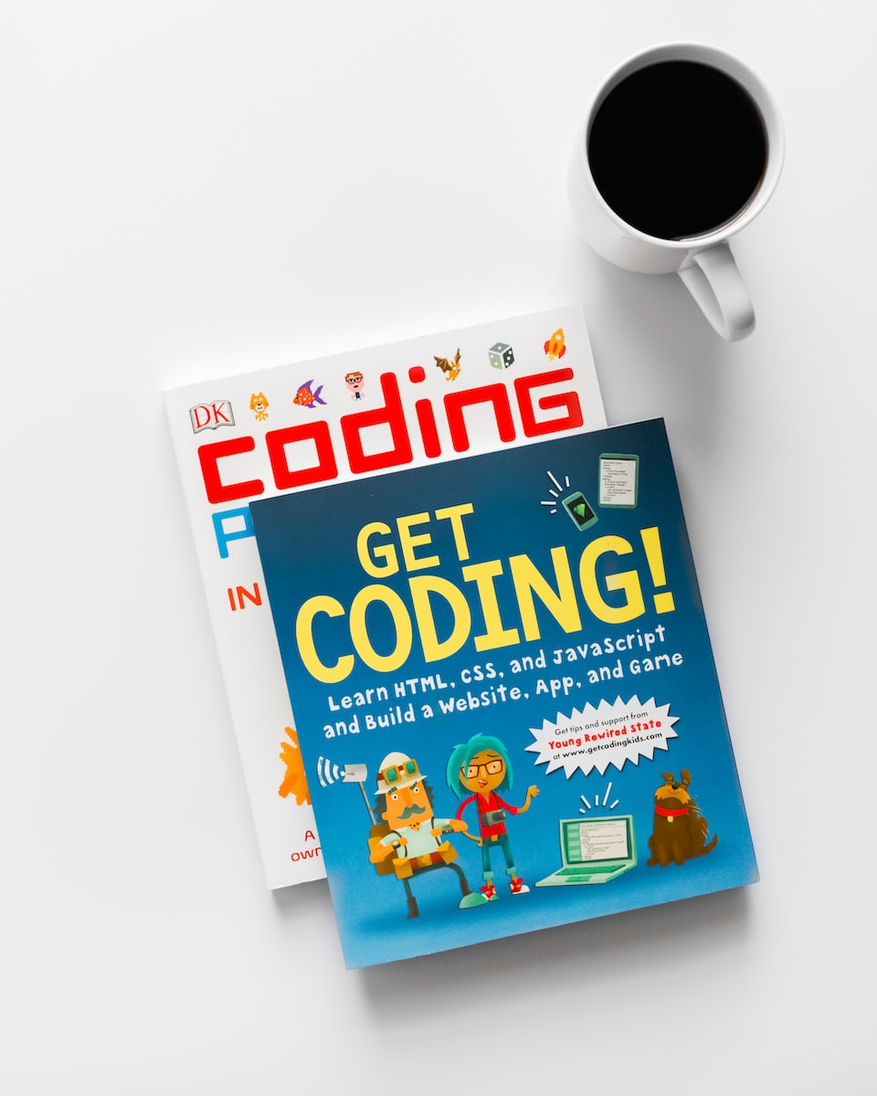 Get Coding and Coding books beside cup of coffee | coding for kids
