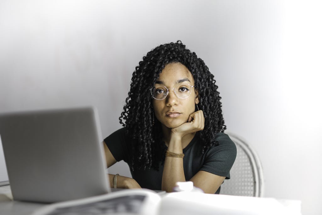 Serious ethnic young woman using laptop to learn product management course
